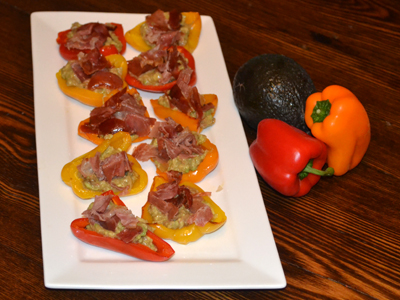 Guacamole stuffed baby peppers with crisped prosciutto