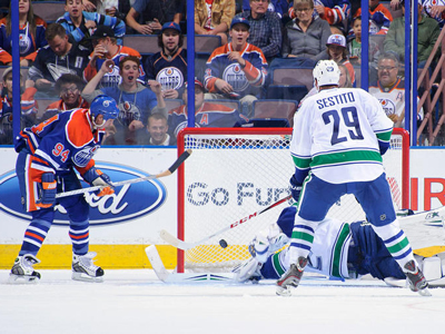 Oilers rollover undermanned Canucks, Rimmer solid in debut